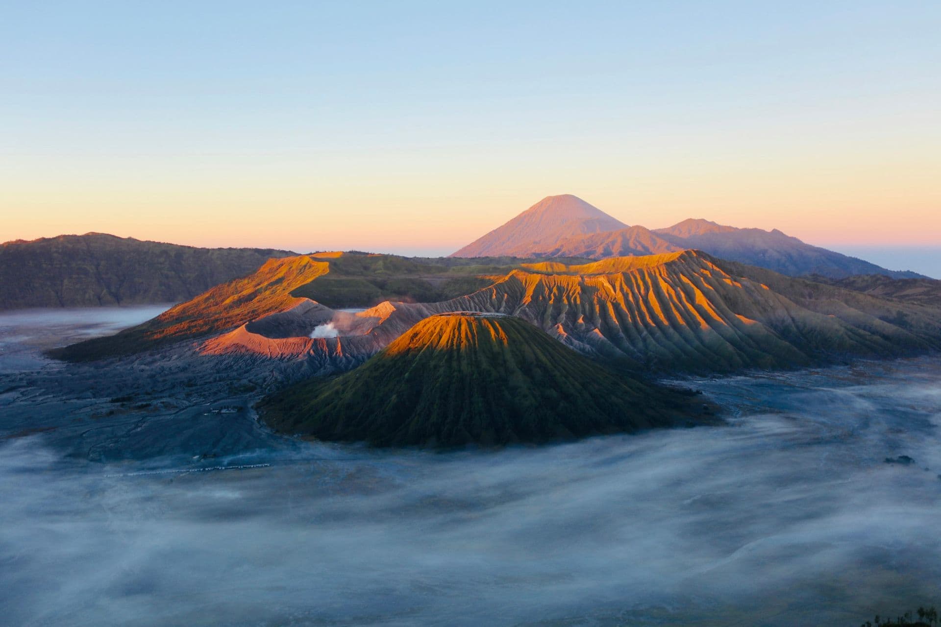 Mount Bromo and its neighbouring volcanoes above a sea of mist at sunrise