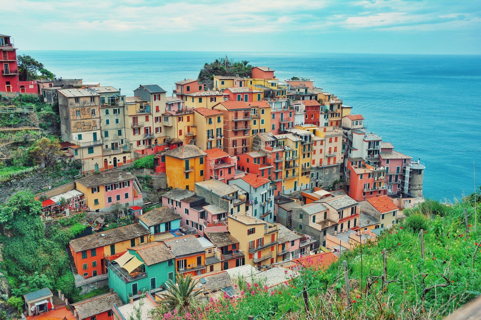 Colourful houses stacked on a headland above the sea in Manarola, Cinque Terre