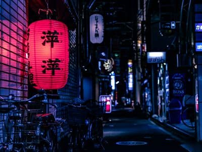 A red paper lantern in a narrow Kyoto street